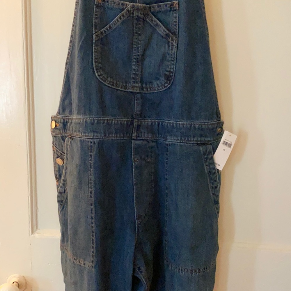Dark wash overalls. Cropped length